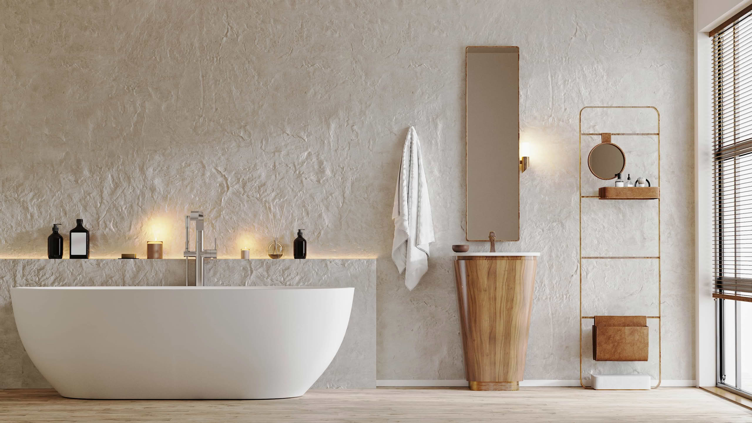 A minimalist bathroom featuring a white freestanding bathtub against a textured plaster wall, a tapered wooden pedestal sink, and warm ambient lighting.